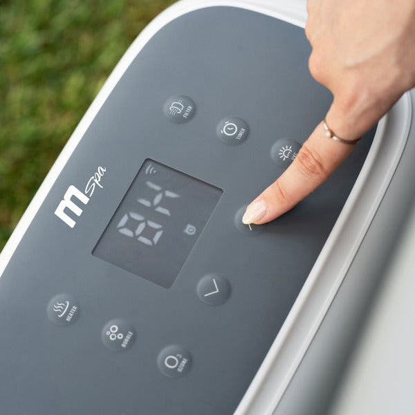 Hand pressing a button on a device with a digital display outdoors