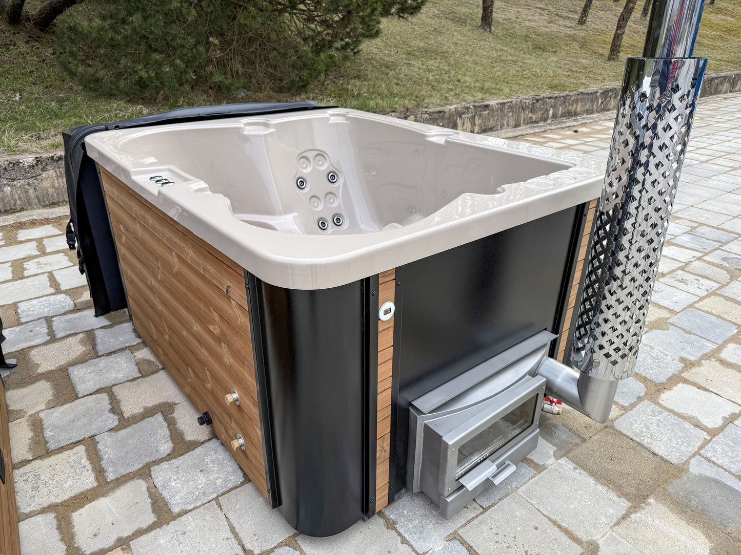Hot tub on a stone patio with outdoor setting